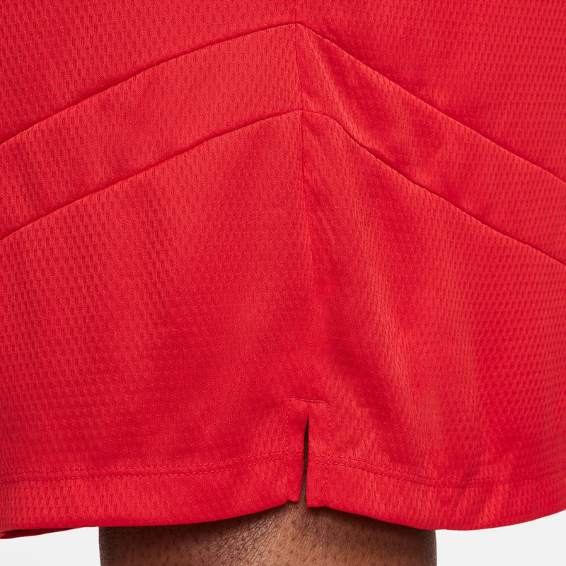 Men's university red shorts close-up of side hem and layered seam detail