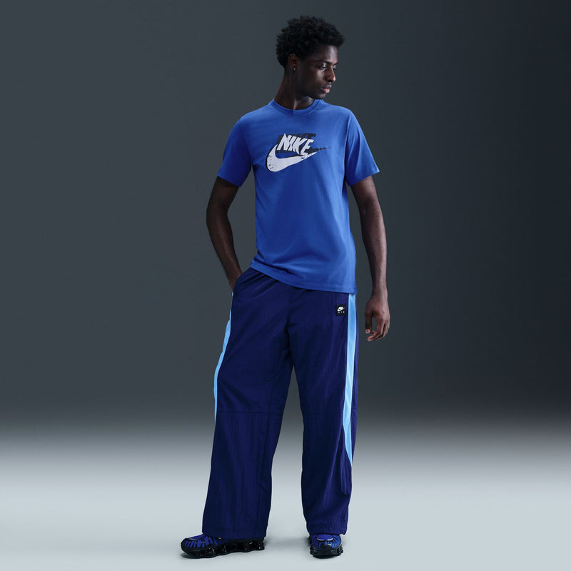 Men's blue T-shirt with Nike front graphic, paired with blue pants