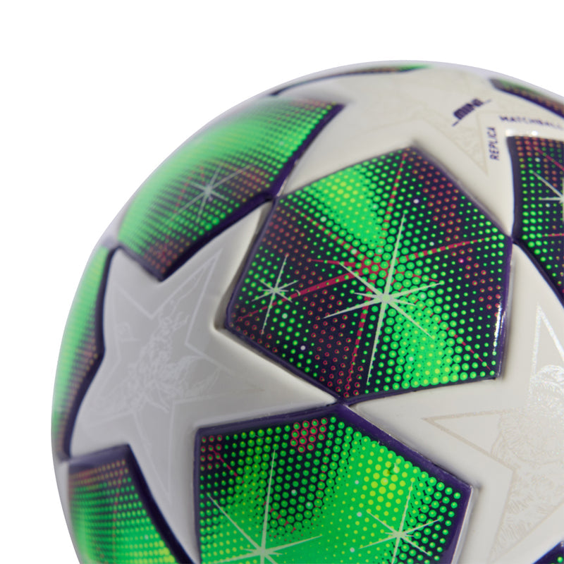 Mini soccer ball close-up with neon green dotted segments and purple accents