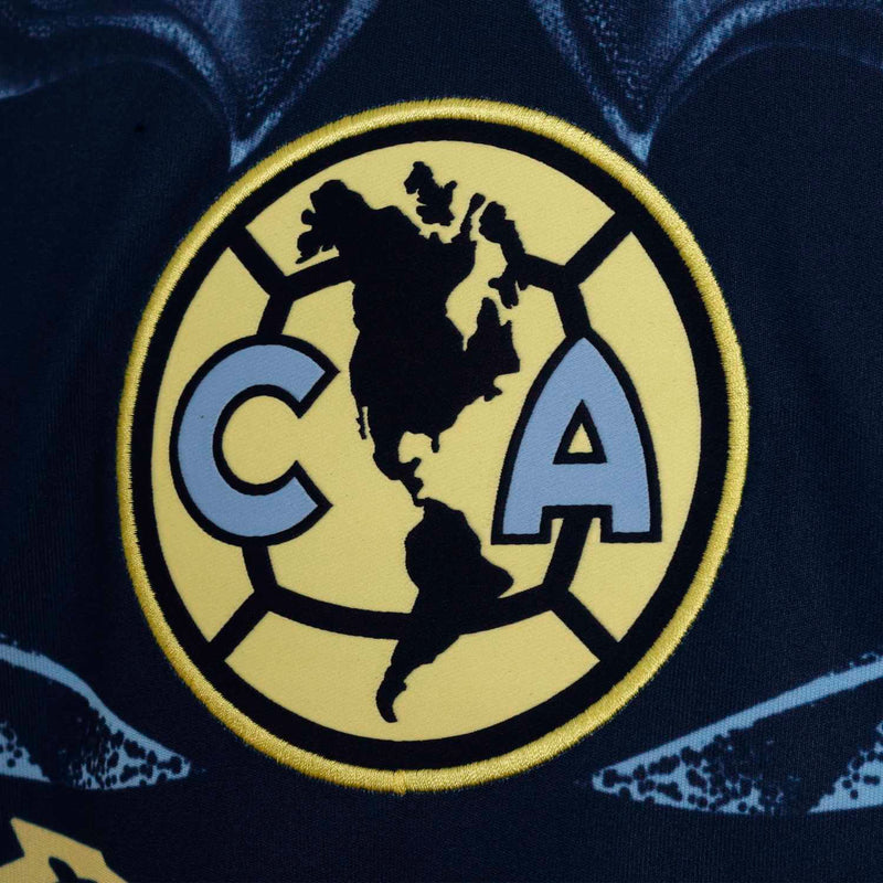 Navy soccer jersey crest patch with gold circular emblem and world map design