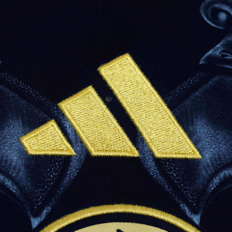 Navy soccer jersey sleeve logo detail with three gold diagonal stripes