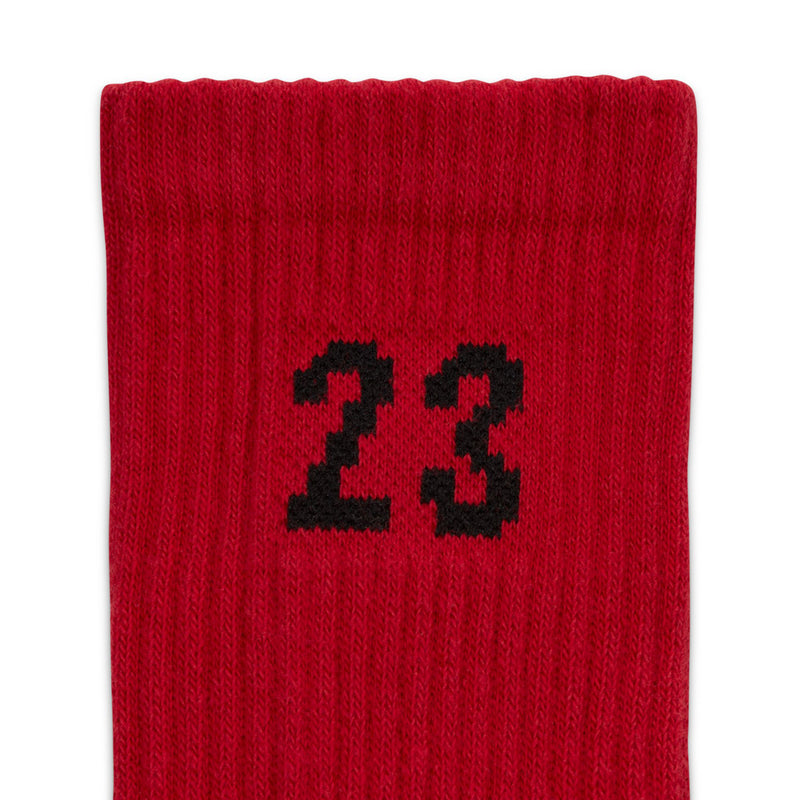 Red crew sock close-up with large black "23" knit graphic