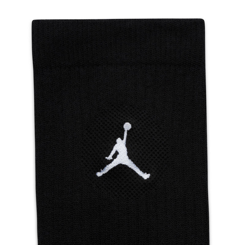Black crew sock close-up with white Jordan logo on knit cuff