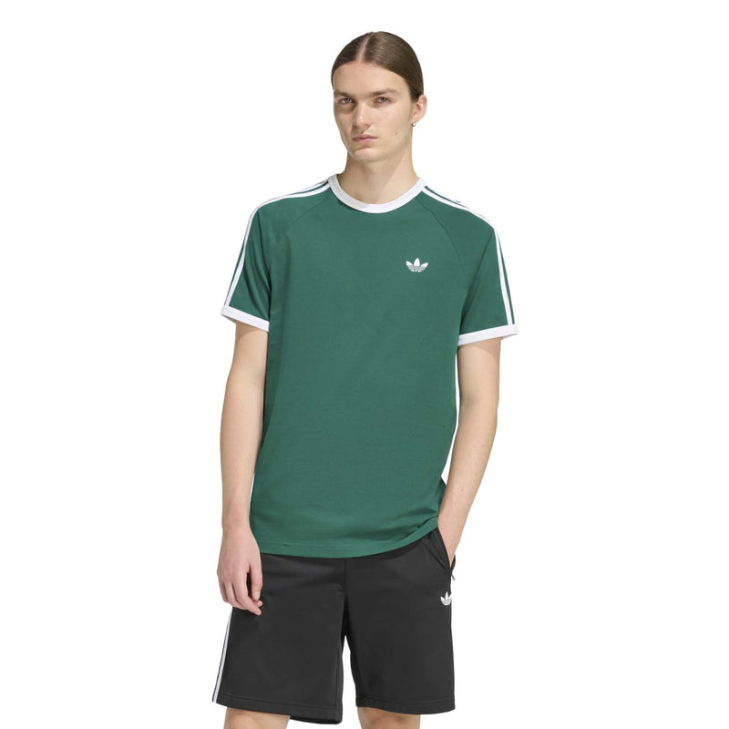 Men's green tee with white crew neck trim, small chest emblem, and three stripe shoulders
