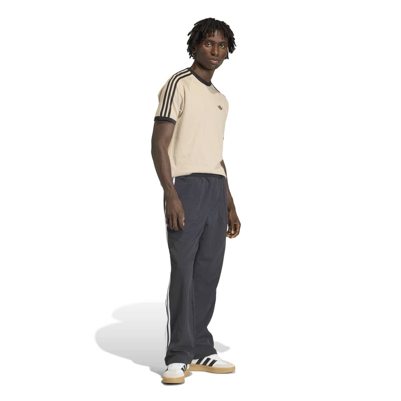 Stone khaki 3-stripe tee with black trim collar, sleeve stripes, and small chest logo