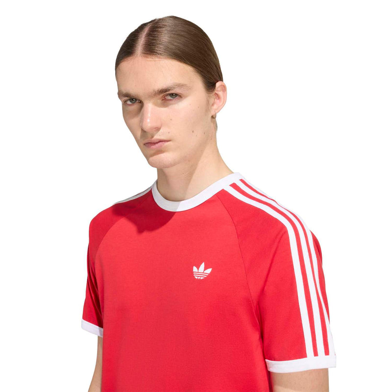 Red Adidas 3-Stripe tee close-up with white ribbed collar and chest trefoil logo