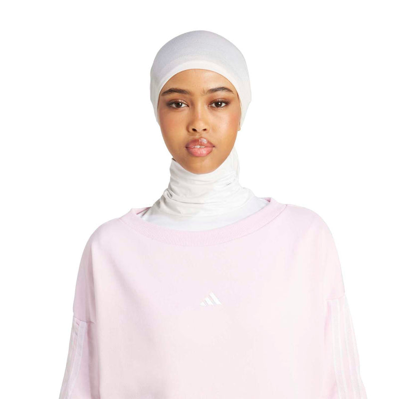Clear pink crewneck sweatshirt with small chest logo and long sleeves, ribbed neckline