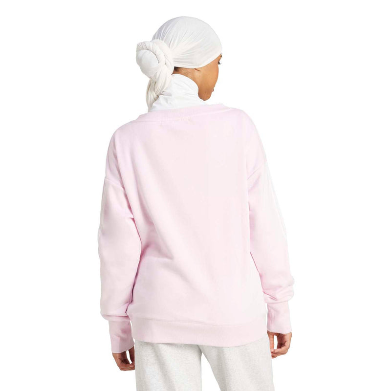 Women's clear pink loose sweatshirt, back view with long sleeves and ribbed hem