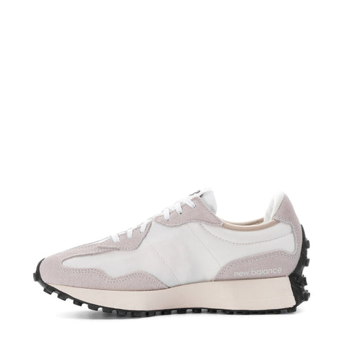 Women's sneakers side view with white upper, blush overlays, and black stripe