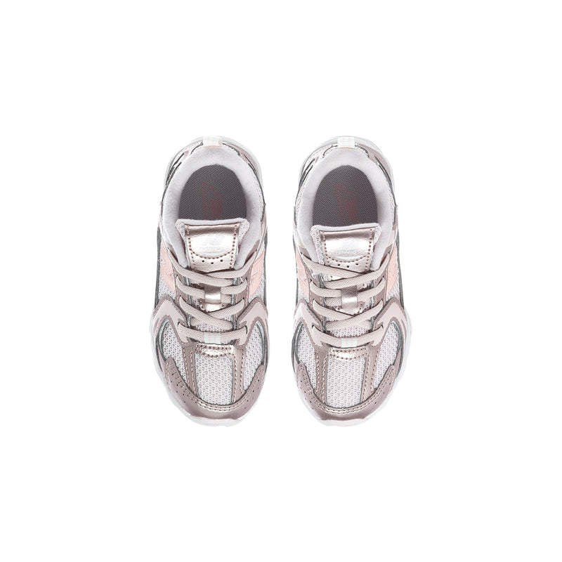 Toddler sneaker pair with light pink lace-up uppers and white rubber toe caps