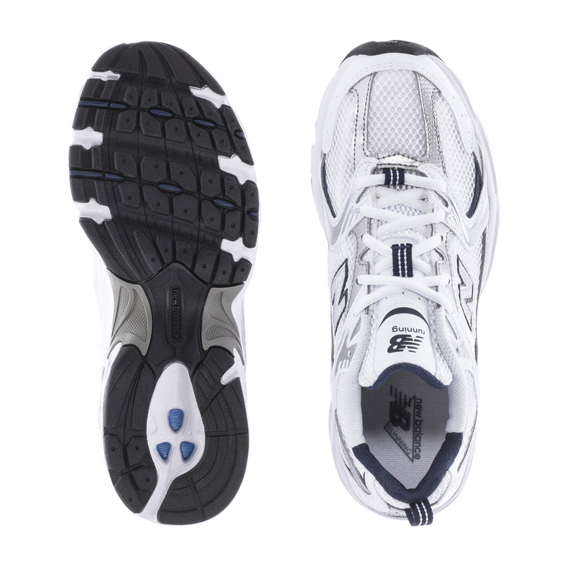 Women’s wide white sneakers showing treaded outsole and mesh upper details.