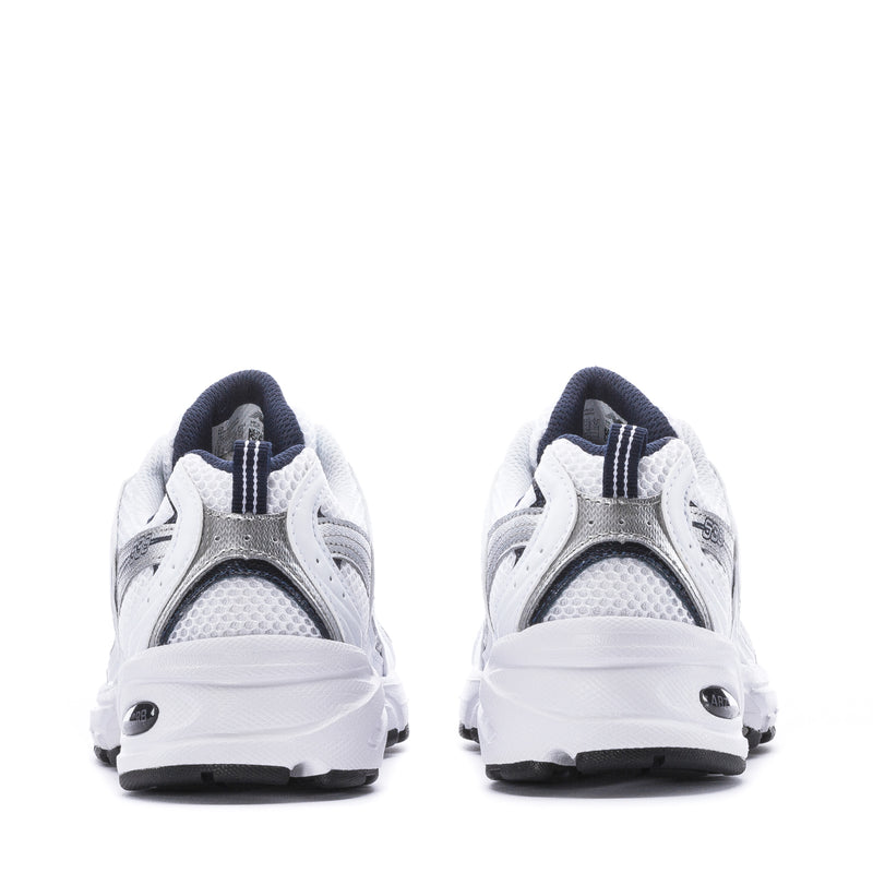 Women’s wide white sneakers showing heel and back mesh panels with navy trim.