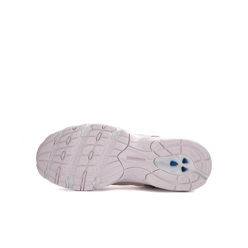 Youth sneaker outsole view with textured grip and light pink rubber tread.