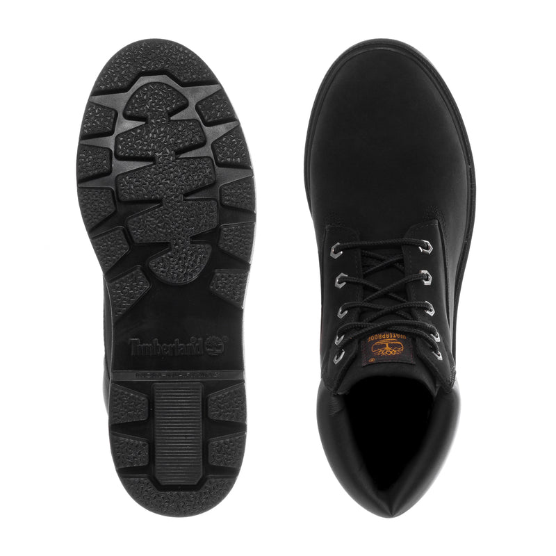Youth black boot outsole and toe view; textured tread and laces with orange logo