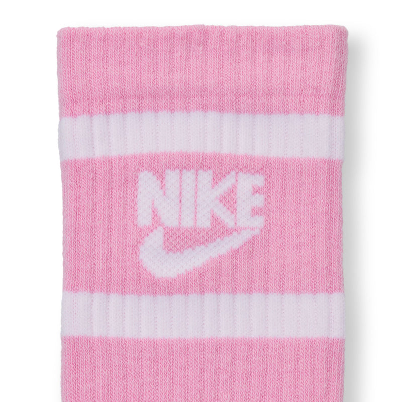 Youth crew socks close-up, pink with white Nike swoosh and stripe bands