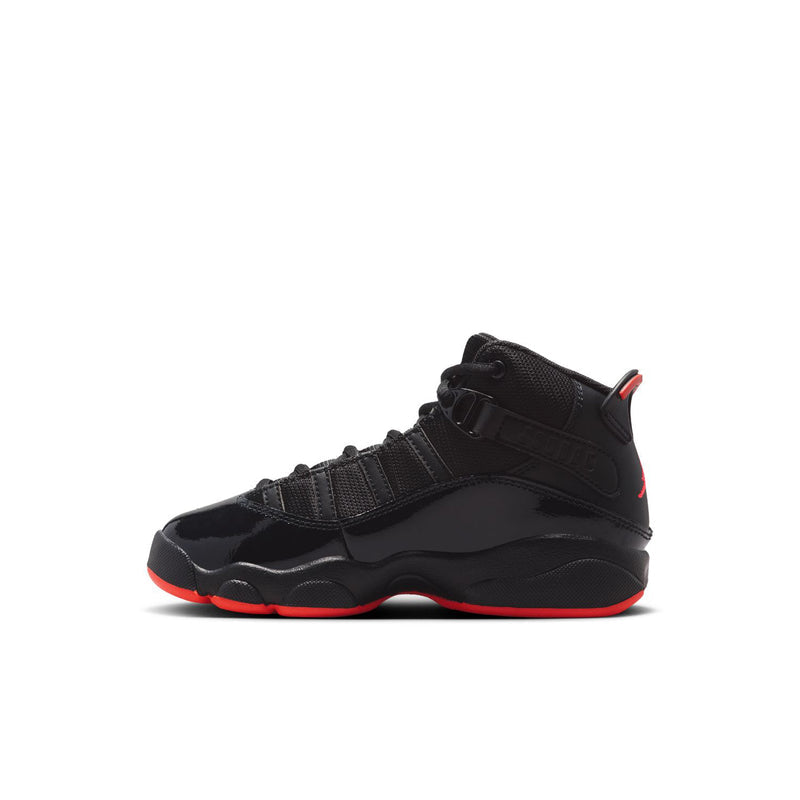 Kids black high-top sneaker with strap detailing and red outsole trim, side view