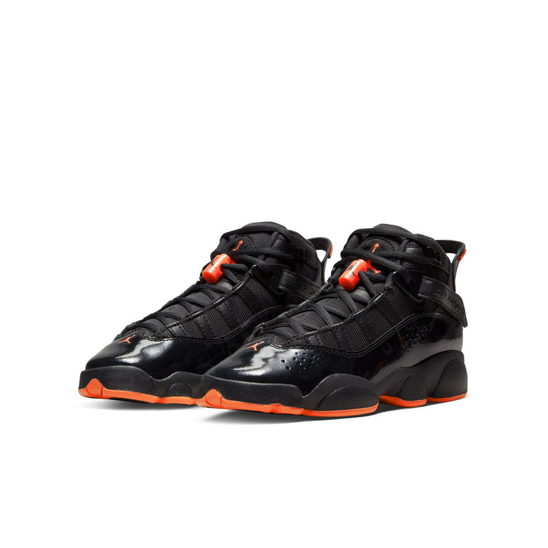 Youth black high-top sneakers with orange-red lace accents and chunky orange outsole