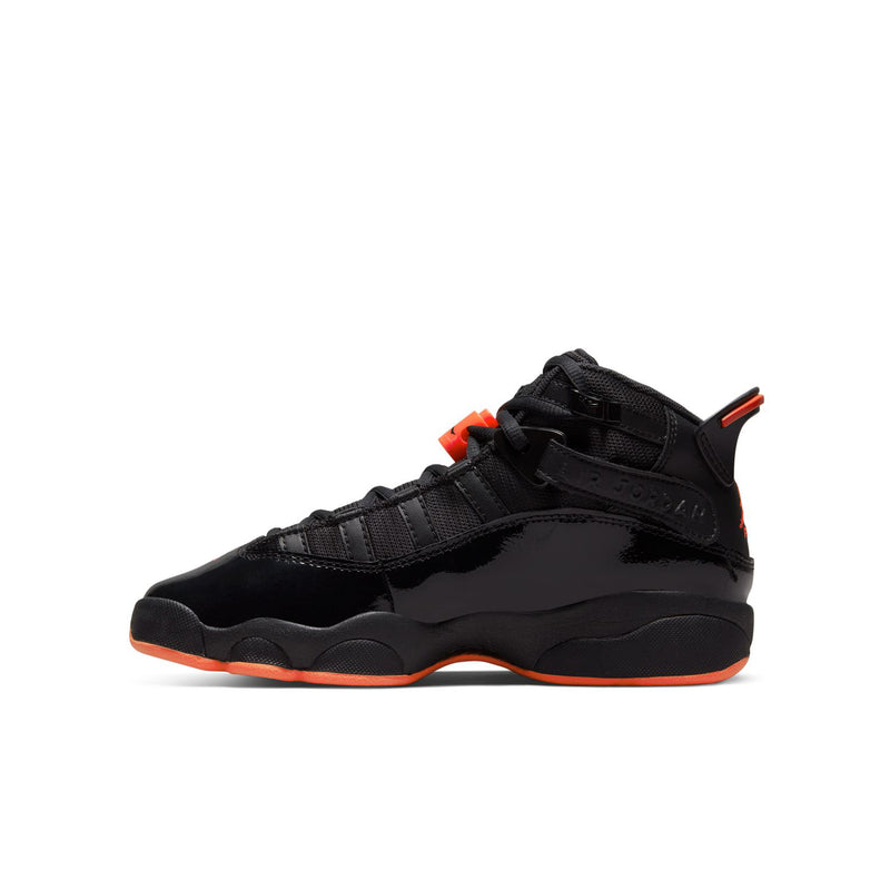 Youth black high-top basketball shoe with red lace accent and orange midsole trim