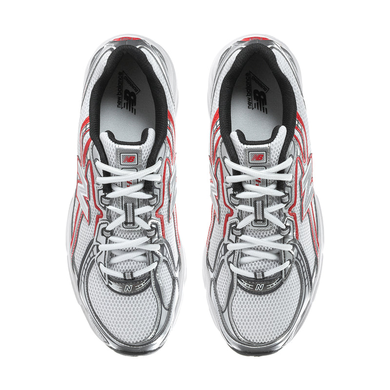 White athletic sneakers with red and gray side stripes, lace-up front and cushioned tongue