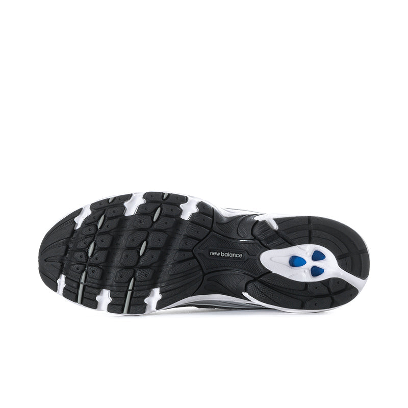 Outsole view of dark athletic running shoes with blue traction insert and tread pattern