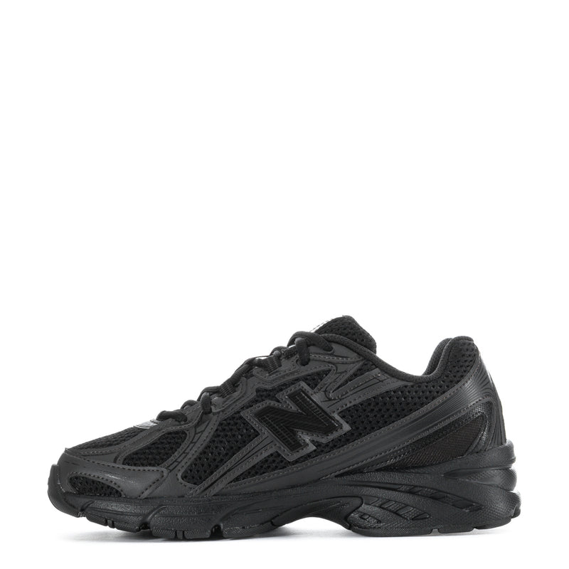 Youth New Balance running sneakers, black gray panels, lace-up with cushioned sole