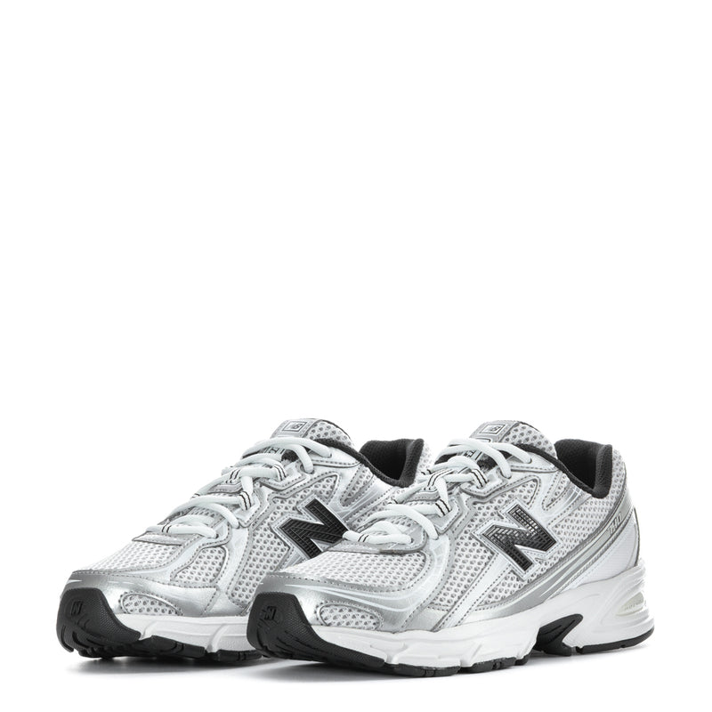 Pair of silver youth running sneakers, lace-up mesh, black accents, New Balance 'N'