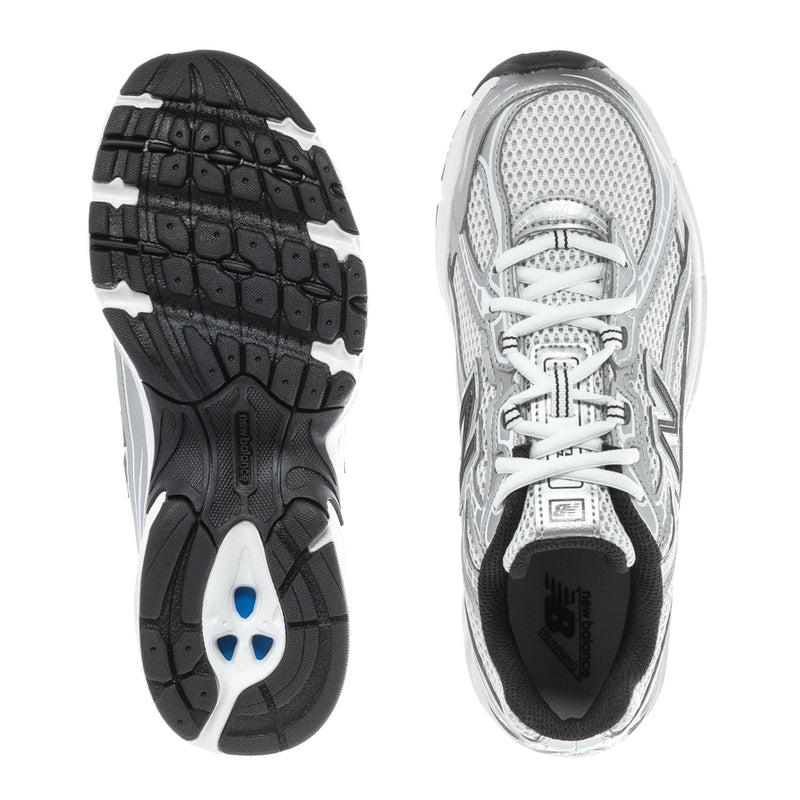 Silver youth running sneaker outsole view, black tread, white laces, black heel