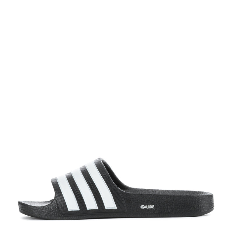 Kids black slide sandals with white triple stripes, side profile