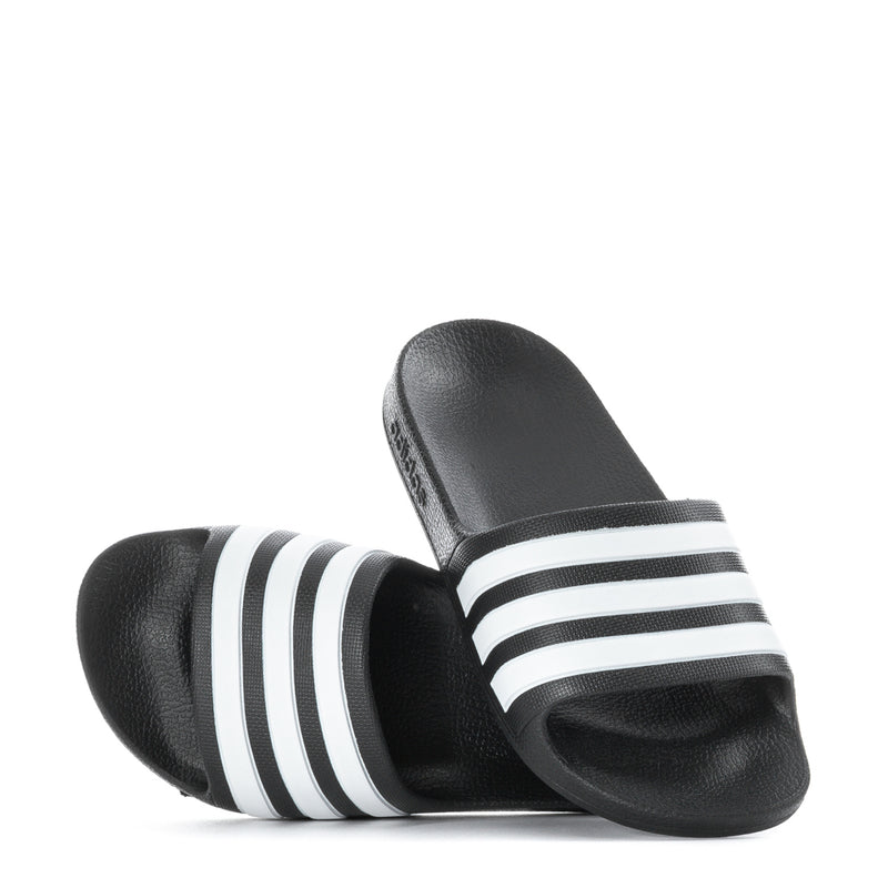 Kids black slide sandals pair with white triple stripes and open toe
