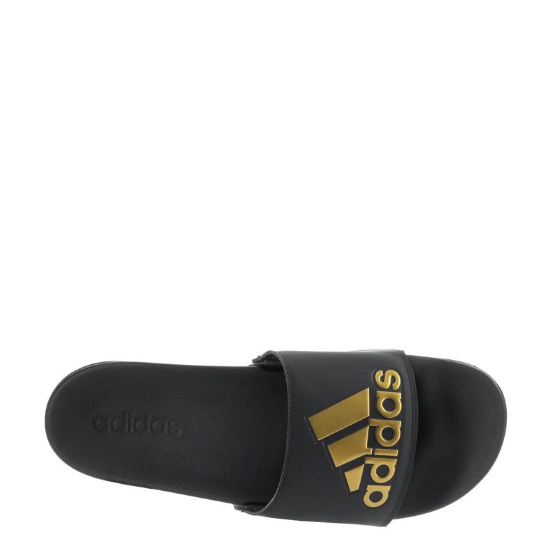 Men's black slide sandals, sole-side view with gold adidas logo on strap