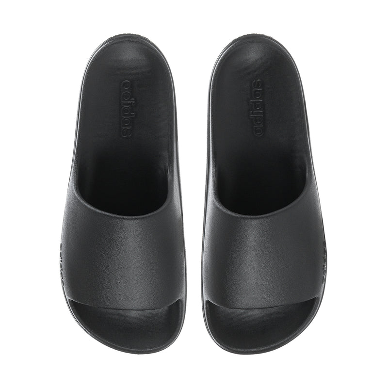 Black slide sandals pair with contoured footbed and logo details on upper