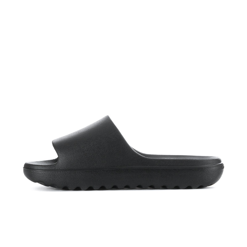 Black slide sandal side view with textured outsole tread and open upper
