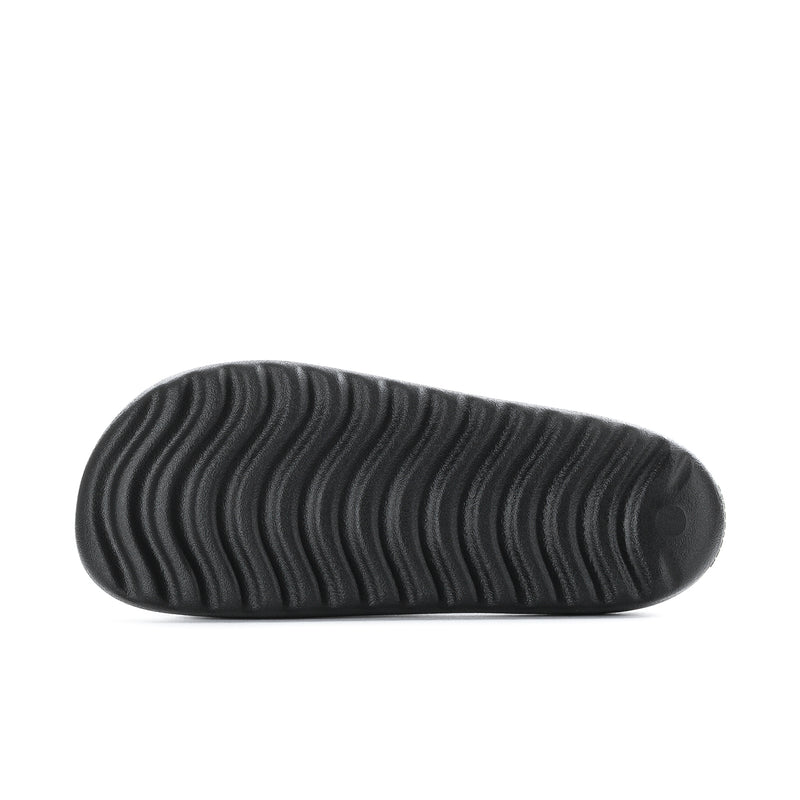 Black rubber sandal outsole with wavy traction pattern tread