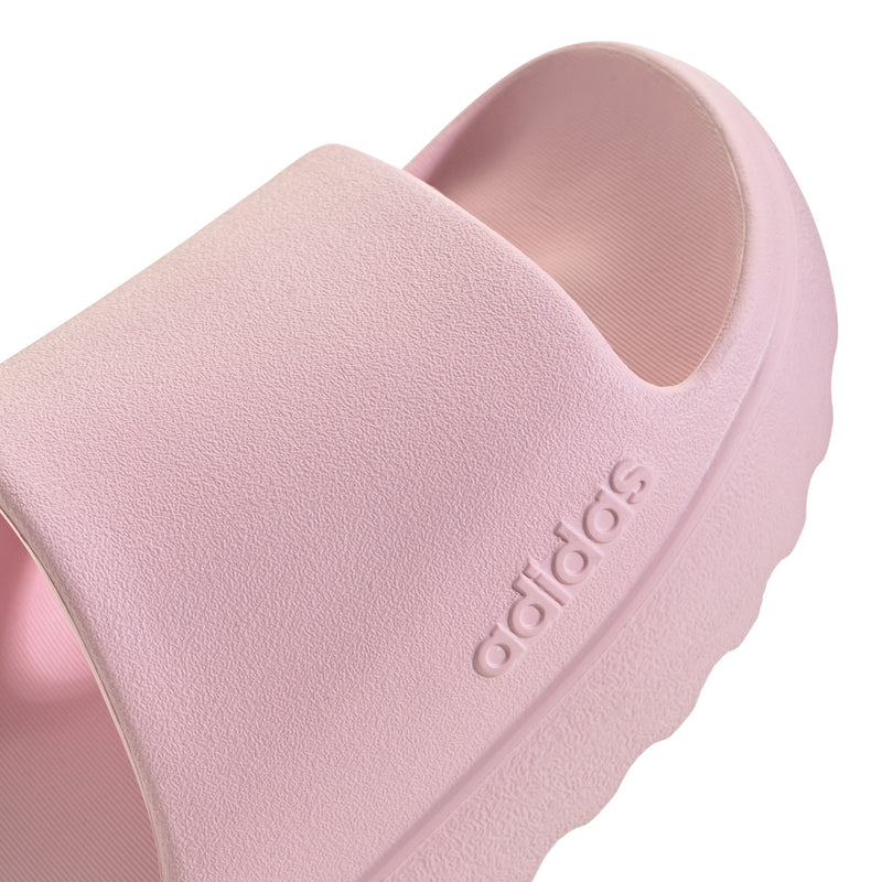 Close-up of clear pink slide sandal strap with adidas logo on the side