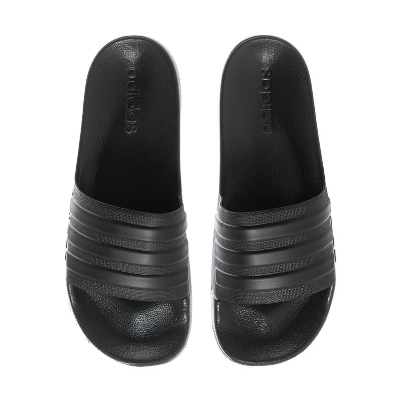 Pair of black slide sandals with adidas branding on the strap and cushioned footbed