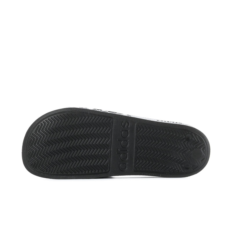 Black slide sandal outsole with chevron tread pattern and adidas logo