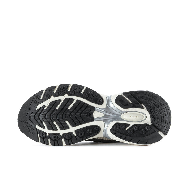Men's running shoe outsole tread with white midsole and dark traction pattern.