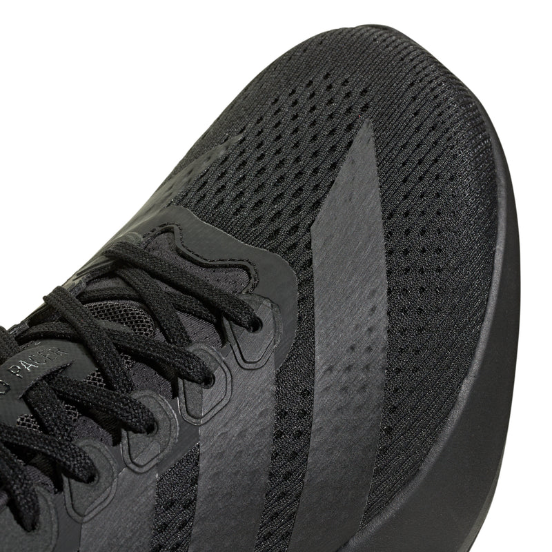 Men's black running shoe close-up of mesh upper and lace panel
