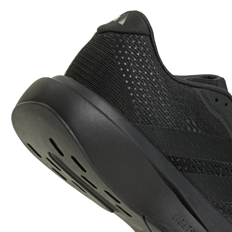 Men's black running shoe close-up of heel and side traction grooves