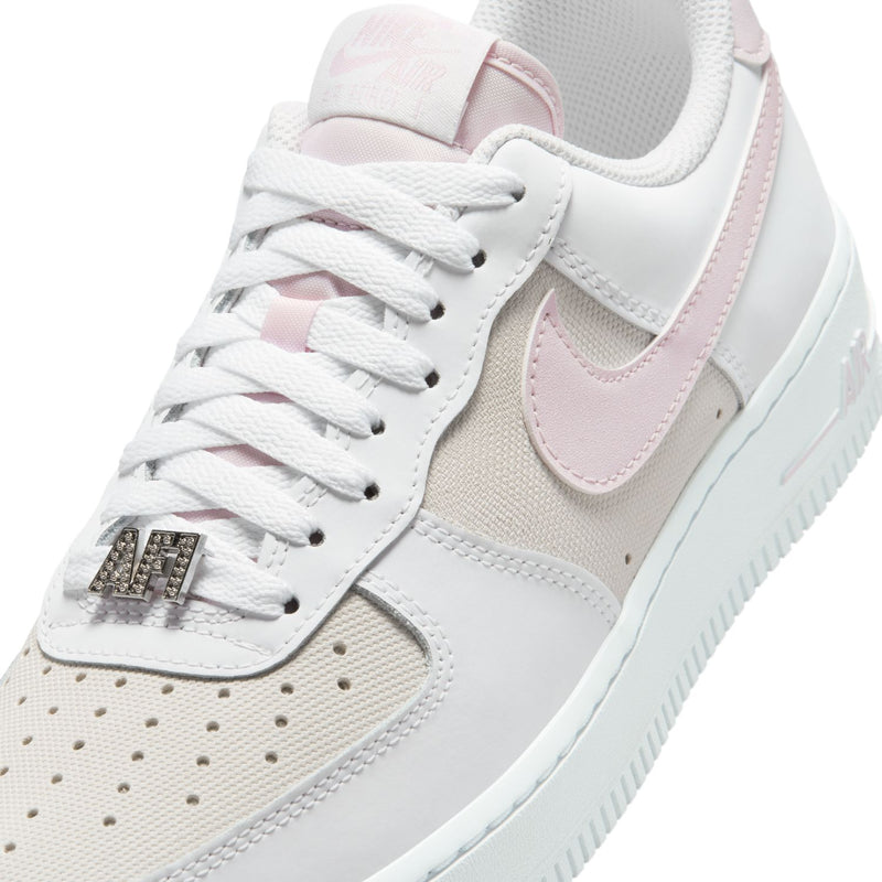 Women's Air Force 1 sneakers, close-up of white laces with lilac swoosh