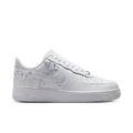 White Nike Air Force 1 low-top sneakers with perforations, lace-up closure, and chunky sole