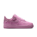 Pink low-top lace-up sneakers with Nike Swoosh and Air sole unit