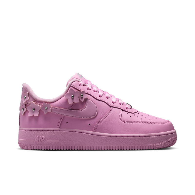 Pink low-top lace-up sneakers with Nike Swoosh and Air sole unit