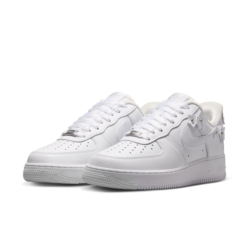 White Nike Air Force 1 sneakers, two-quarter view with laces, swoosh, and textured rubber sole