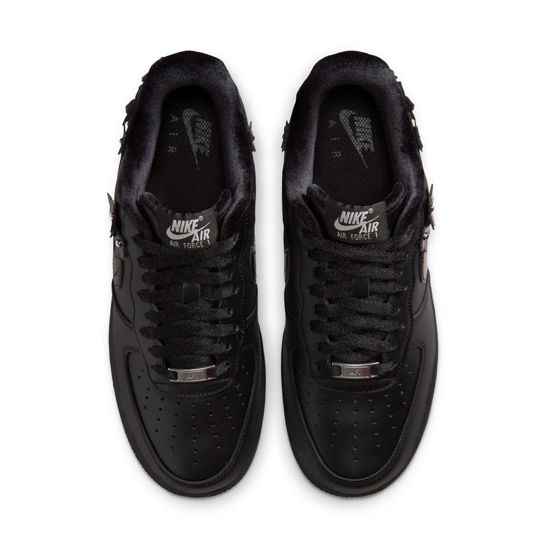 Pair of women's black low-top sneakers, top view with lace-up and perforated toe