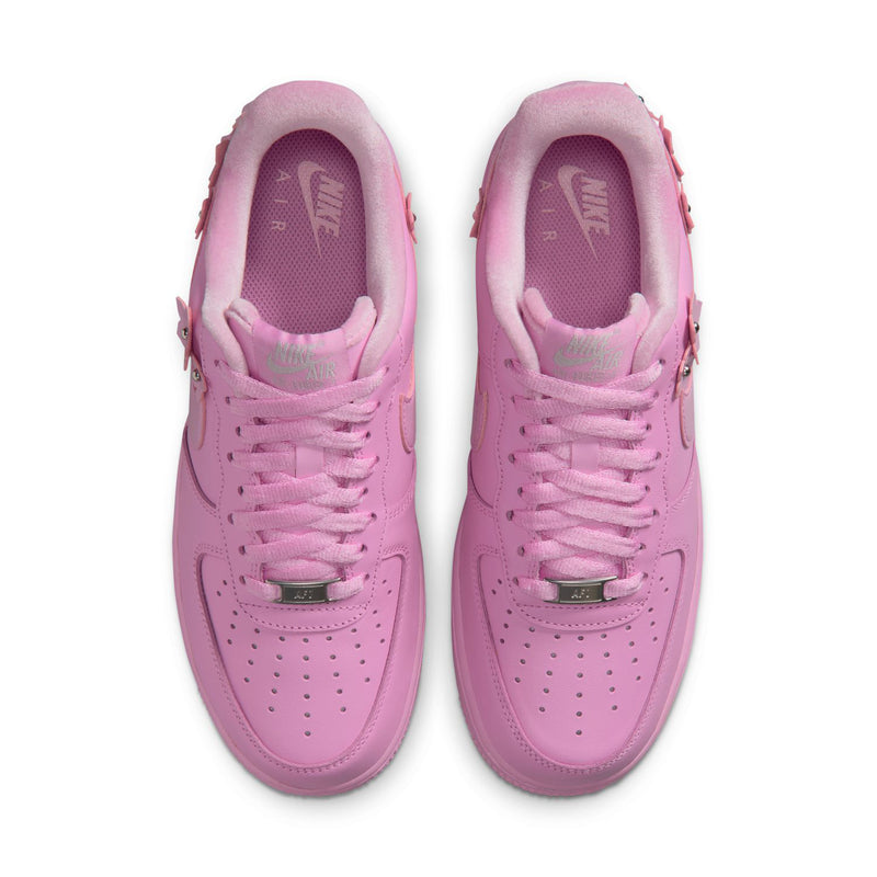 Pink low-top sneakers viewed from above with lace holes and perforated toe