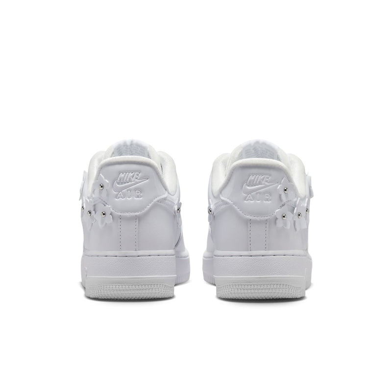 Back view of white Nike Air Force 1 sneakers with heel tab and lace-up collar