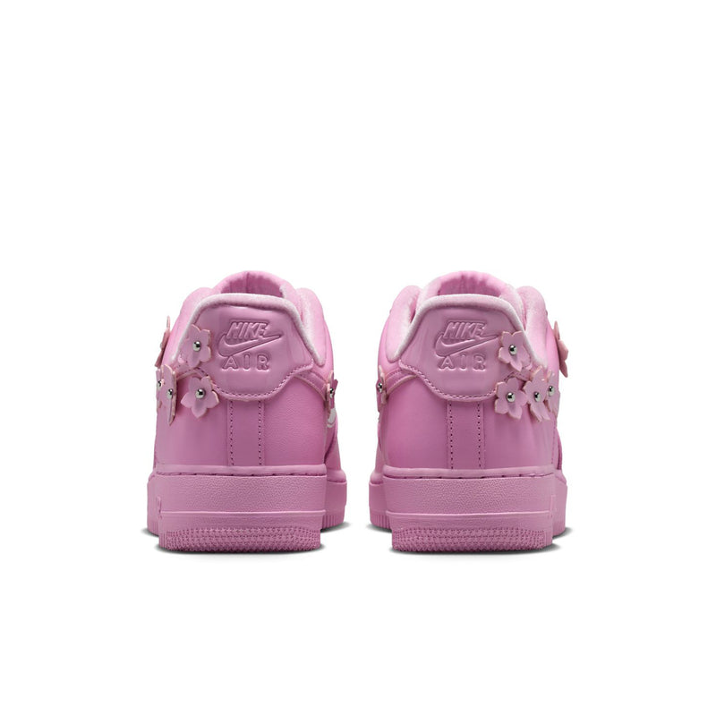 Pink low-top sneakers from back with lace-up collar and padded heel