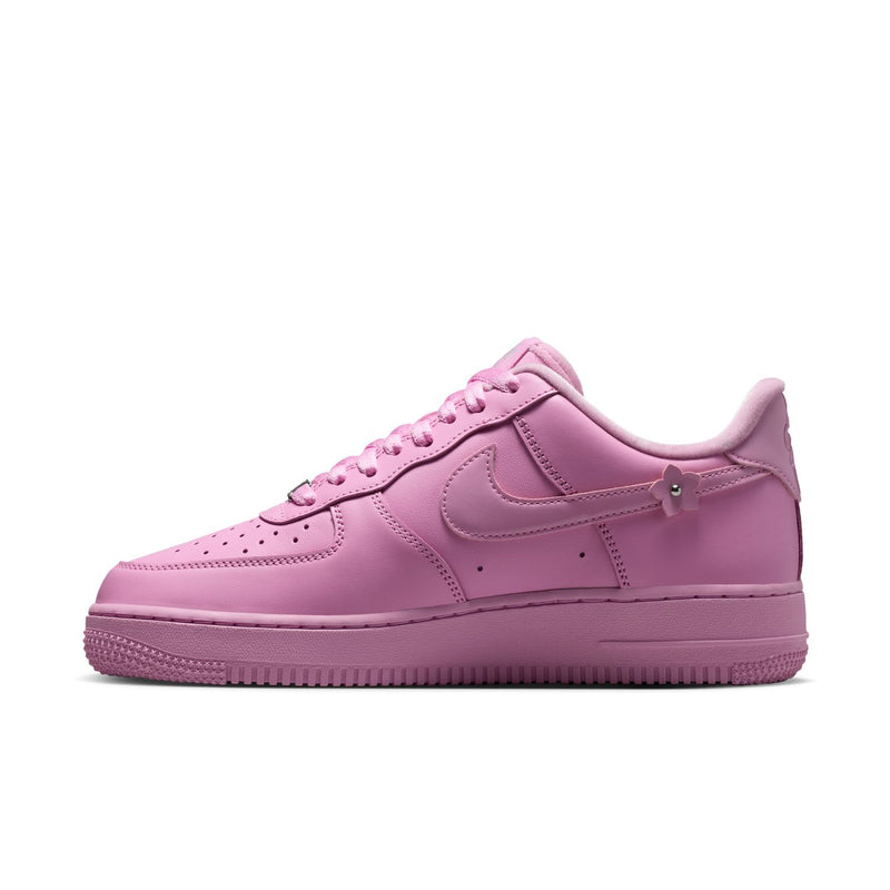 Pink low-top lace-up sneakers with Nike Swoosh and textured rubber sole