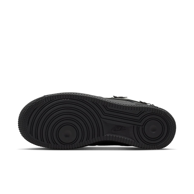 Women's black low-top sneaker outsole view with durable tread and Nike logo